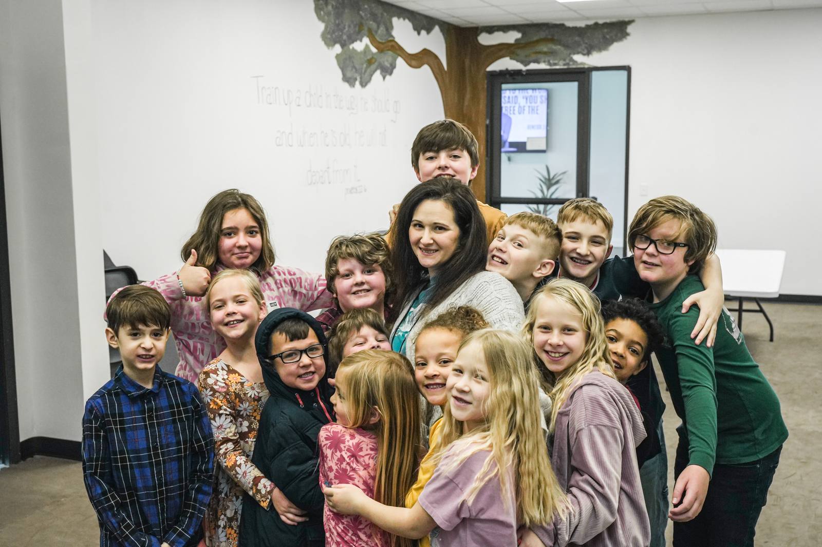 Awaken Kids leader with a room full of kids